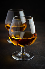 Glass of brandy or cognac on the old rusty background Selective focus