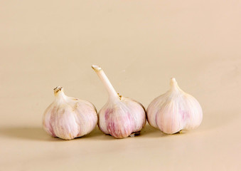 Fresh garlic on a beige background. Ostrich spice for eating. Horizontal image.
