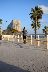 Boy is riding a Monowheel along the beach and speaking on mobile phone   © Olga