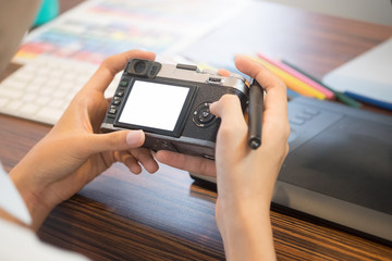 Closeup photography selective photo in camera with photographer table creative concept.
