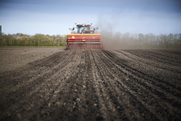 Red tractor plow field