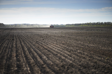 Red tractor plow field