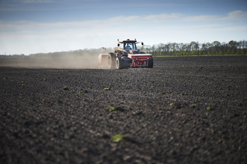Red tractor plow field