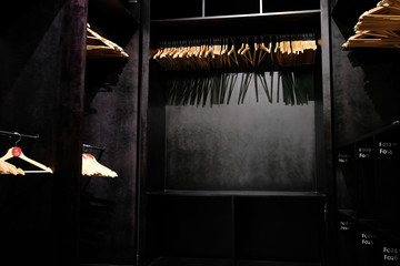 Empty wooden clothes hangers casting deep shadows. 