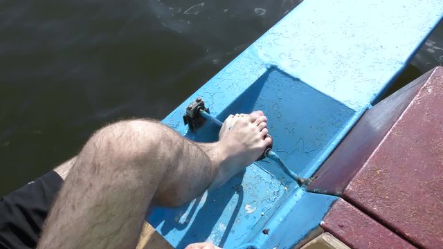 Pedal boat. Rotate the pedals on a catamaran legs