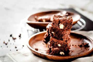 pyramid of freshly prepared home fresh brownies with nuts and figs, on a black background