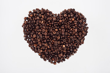 close-up view of heart made from roasted coffee beans isolated on white