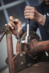 farmer repair his agricultural machine
