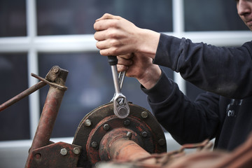 farmer repair his agricultural machine