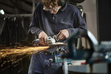 young farmer working with a grinder