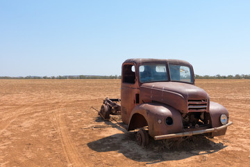 Rusty abandoned truck in dry landscape in Queensland