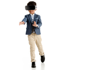 african american boy using vr headset and walking isolated on white