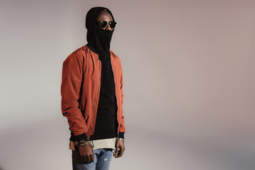 Stylish young african american man wearing hood with face mask