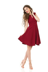 Happy Young Woman Is Posing In Red Dress And High Heels