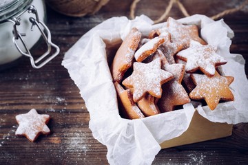Homemade baked Christmas gingerbread cookies with icing sugar in the box