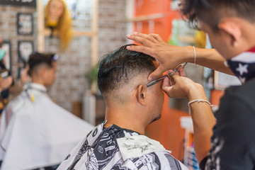 Barber haircut a customer at barbershop