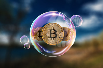 Gold Coins Bitcoin in a soap bubble. The concept of instability of the crypto currency, electronic...