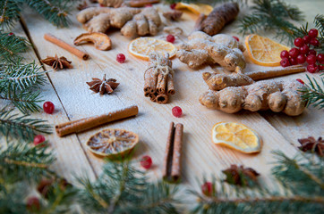 Powdered spices for mulled wine Christmas bakery orange, anise, cinnamon, ginger, viburnum on wooden background. Decorated with Christmas tree branches, pine cones. New year composition. Side view