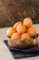 Small cottage cheese doughnuts (castgnole) served in a vintage bowl. Festive dessert.