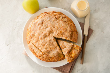 Irish apple pie on a white plate with vanilla custard sauce. Festive dessert for St.Patricks Day.