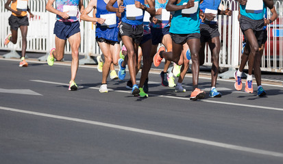 marathon runner legs running on city road