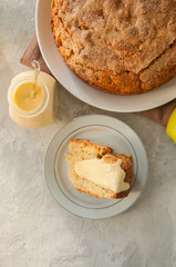 Irish apple pie on a white plate with vanilla custard sauce. Festive dessert for St.Patricks Day.