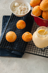 Small cottage cheese doughnuts (castgnole) served on a wire rack.