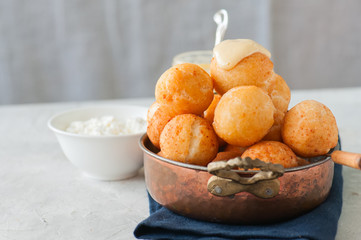 Small cottage cheese doughnuts (castgnole) with vanilla curd served in a vintage bowl.