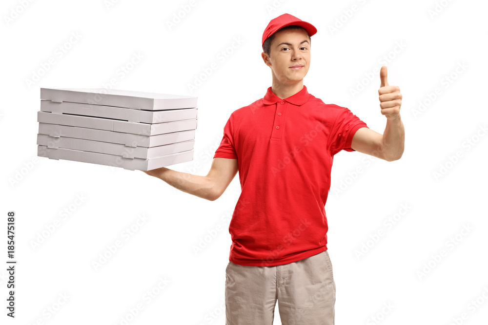 Wall mural teenage pizza delivery boy holding a stack of pizza boxes and making a thumb up sign