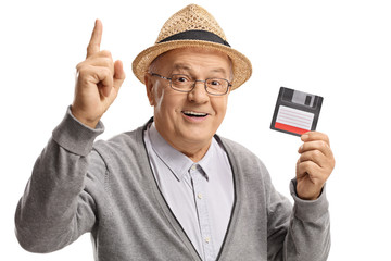 Mature man with a floppy disk holding his index finger up - Powered by Adobe