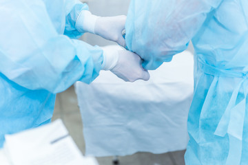 Fototapeta premium the hands of surgeons physicians doing surgery to the patient in the clinic, the concept of photo medicine, professional doctors, anesthesia