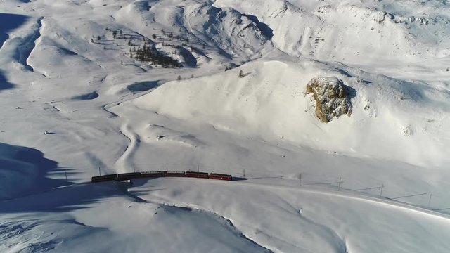 Swiss Alps, Bernina Express, red train of Bernina, Unesco heritage. Winter landscape