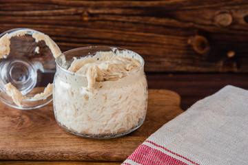 Active wheat sourdough starter in glass jar. Lievito Madre.