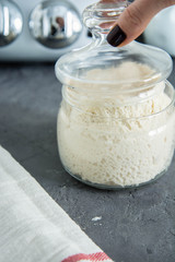 Active wheat sourdough starter in glass jar. Lievito Madre.