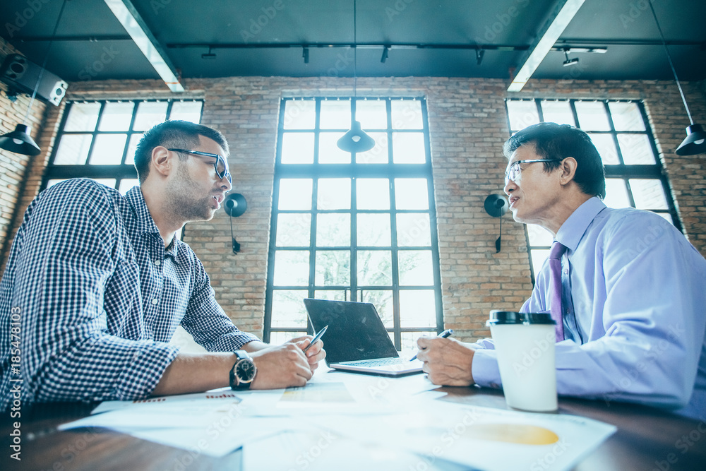 Wall mural business partners negotiating in loft office