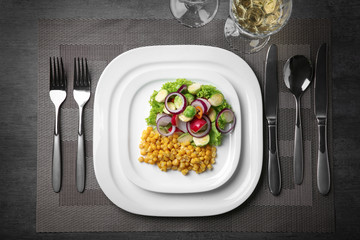 Plate of tasty salad with Brussels sprouts on table