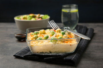Baking dish with Brussels sprouts and cheese on table