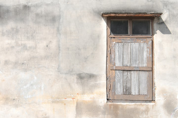 Fototapeta na wymiar Old grunge wooden window isolated on cement wall