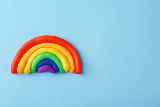 Plasticine rainbow on color background