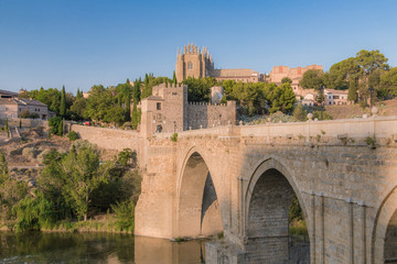 Fototapeta na wymiar View of old stone bridge Puente de San Martín in Toledo, Spain