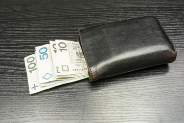 Wallet with banknotes being a means of payment in Poland or Polish Zloty.