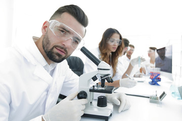 closeup of male technician sitting at his working in the laboratory