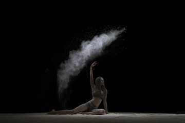 Fototapeta na wymiar Woman sitting on the floor in white dust cloud