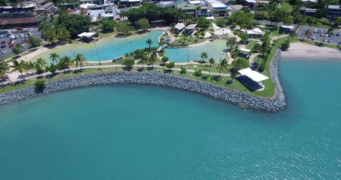 WHITSUNDAY ISLANDS &ndash; FEBRUARY 2016 : Aerial shot over Airlie Beach cityscape on a beautiful day with swimming pool and beach in view
