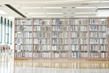 Fototapeta Abstract blurred bookshelf in library room. obraz