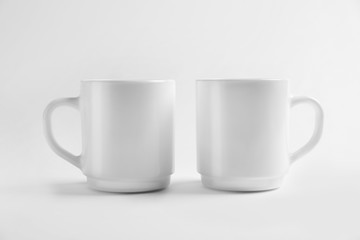Ceramic cups on white background. Mockup for design
