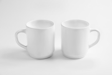 Ceramic cups on white background. Mockup for design