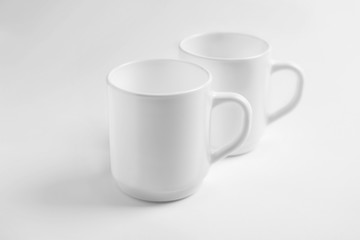 Ceramic cups on white background. Mockup for design