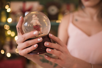 young beautiful woman in a room decorated for celebrating the new year and christmas