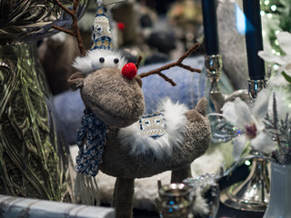 Christmas card with deer and christmas gifts over tree. Belgium, 2017